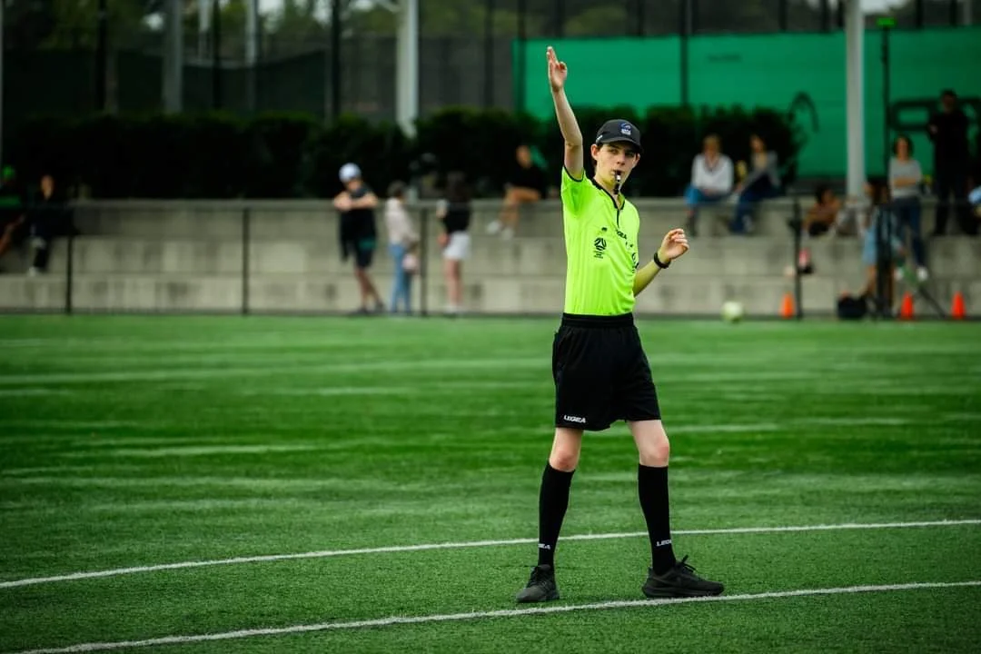 Young referee signalling