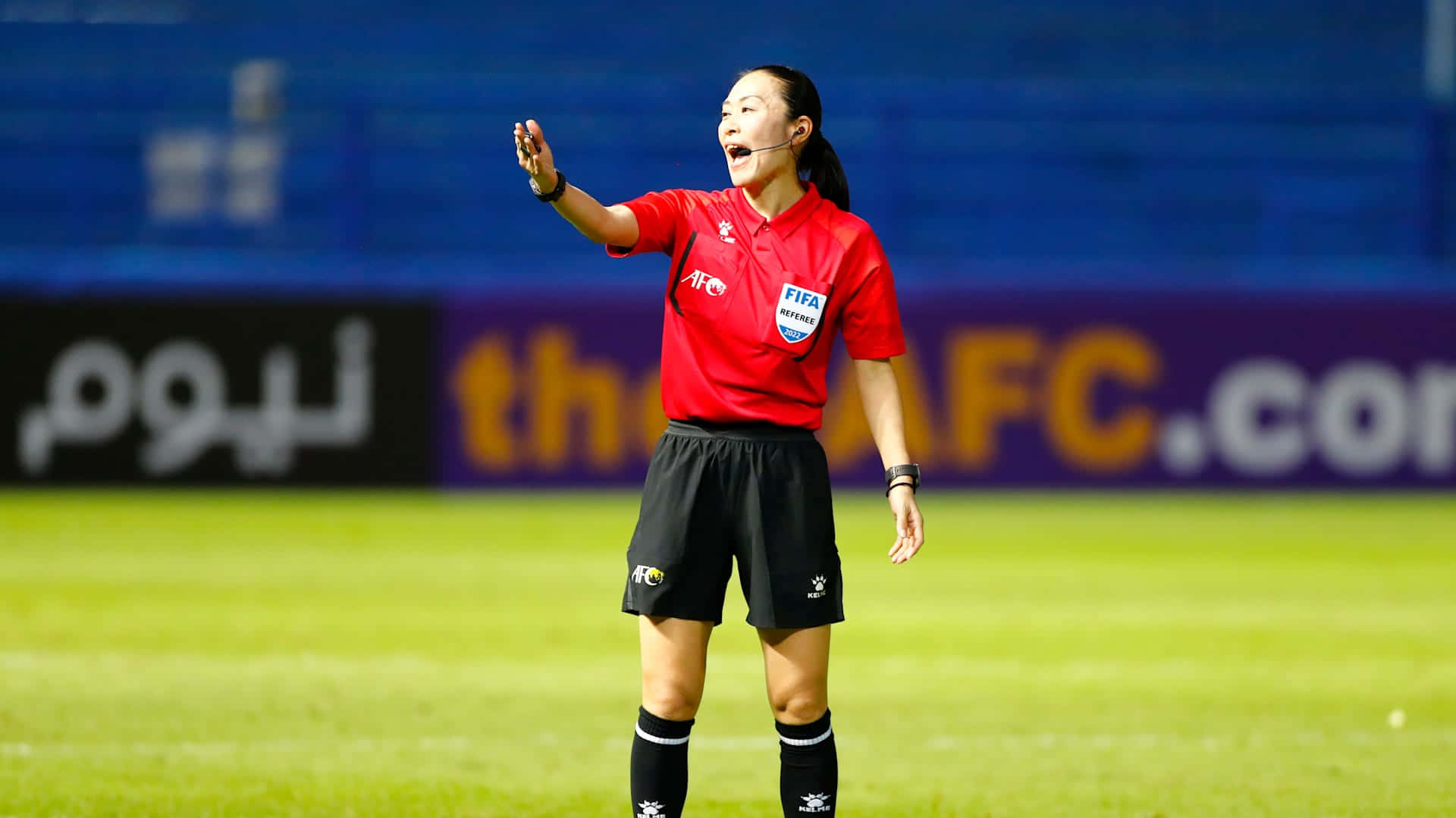 Referee signalling on the field.